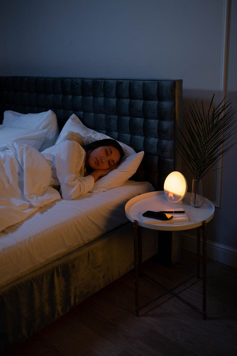 Woman sleeping peacefully on her side in bed